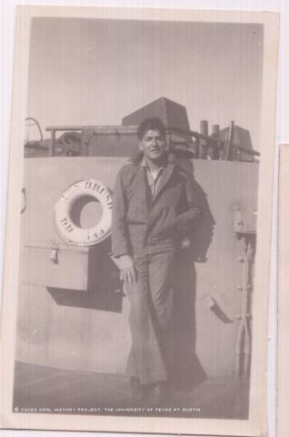 This is a photo of Jesus Munoz in San Diego standing on deck of the USS Brush in work clothes. The photo was taken in 1948 while Munoz was taking a break.