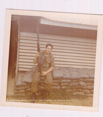 Ernesto Torres at the Lane Air Field Base in front of his barracks (Hooch) in April 1971.\Holding my M16 rifle.\""